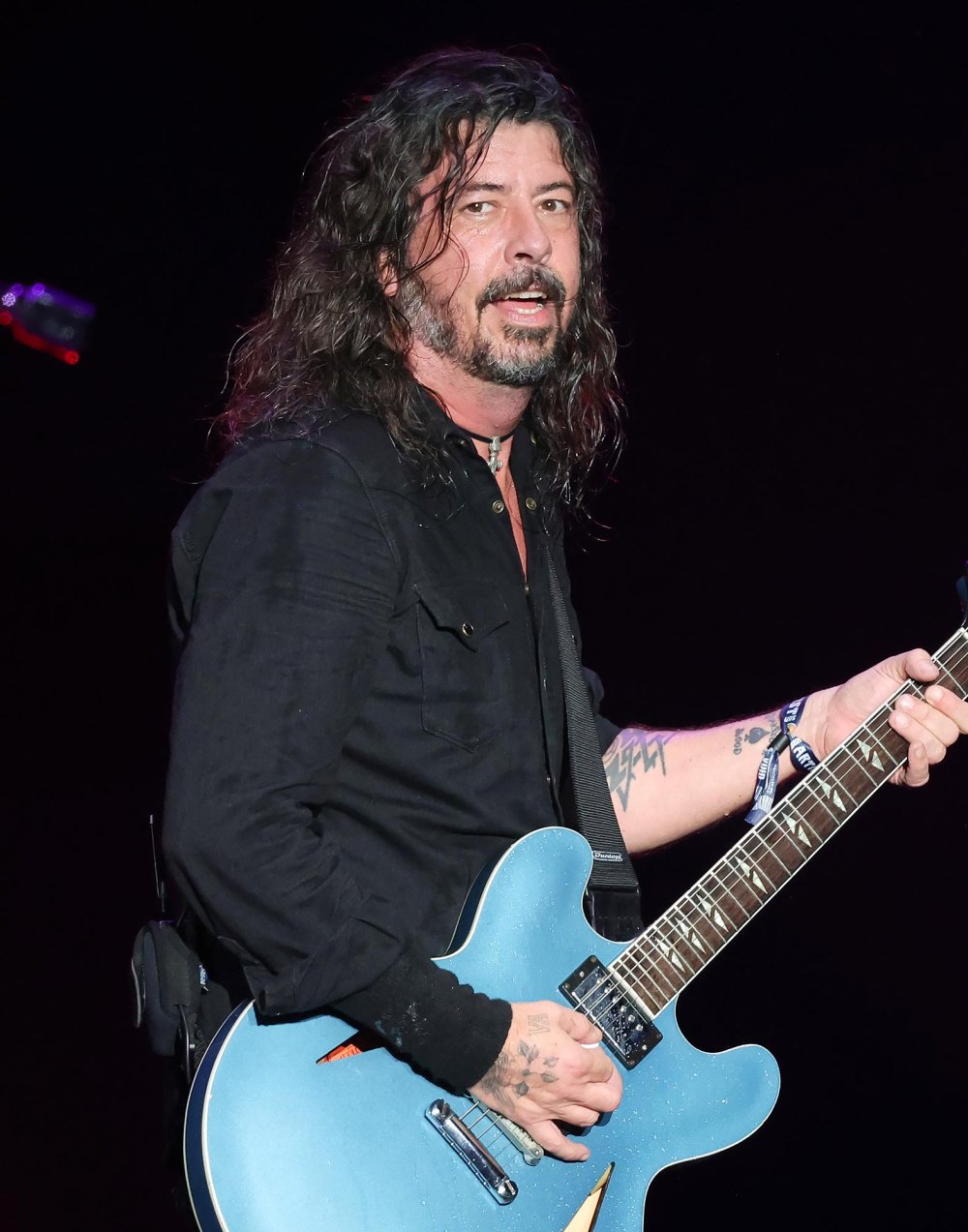 Участник группы Foo Fighters Дэйв Грол приветствует девочку вне брака